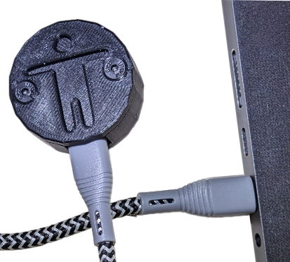 The ally keys device plugged into a computer via a usb cable